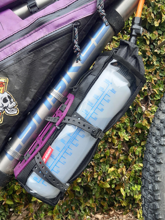 Mountain bike hydration system Nalgene bottle and drinking hose under bike frame for bikepacking, water bladder replacement.