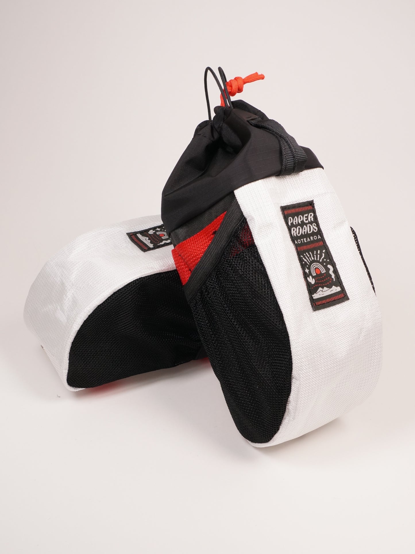 Large handlebar stem bag treat bag for cycling, commuting or bikepacking. Easy access to snacks or bottle, one handed opening. Brown with white top. Ultra tech fabric in white, with red. Made in New Zealand.