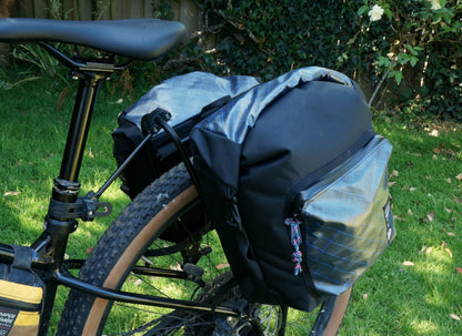 Bikepacking touring roll top panniers 12L. Custom handmade ultralight waterproof, sturdy for riding gravel and mountain bike trails. Made in Auckland, New Zealand bike bags. 