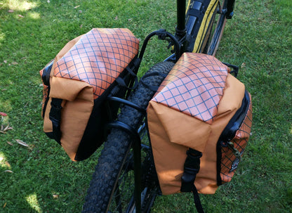 Bikepacking touring roll top panniers 12L. Custom handmade ultralight waterproof, sturdy for riding gravel and mountain bike trails. Made in Auckland, New Zealand bike bags. 