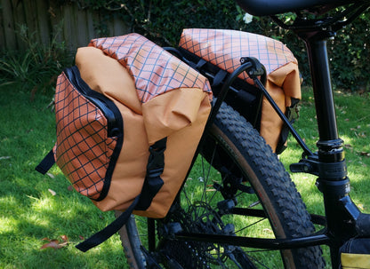 Bikepacking touring roll top panniers 12L. Custom handmade ultralight waterproof, sturdy for riding gravel and mountain bike trails. Made in Auckland, New Zealand bike bags. 
