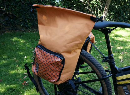 Bikepacking touring roll top panniers 12L. Custom handmade ultralight waterproof, sturdy for riding gravel and mountain bike trails. Made in Auckland, New Zealand bike bags. 