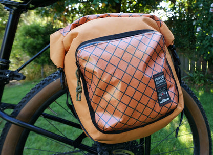 Bikepacking touring roll top panniers 12L. Custom handmade ultralight waterproof, sturdy for riding gravel and mountain bike trails. Made in Auckland, New Zealand bike bags. 