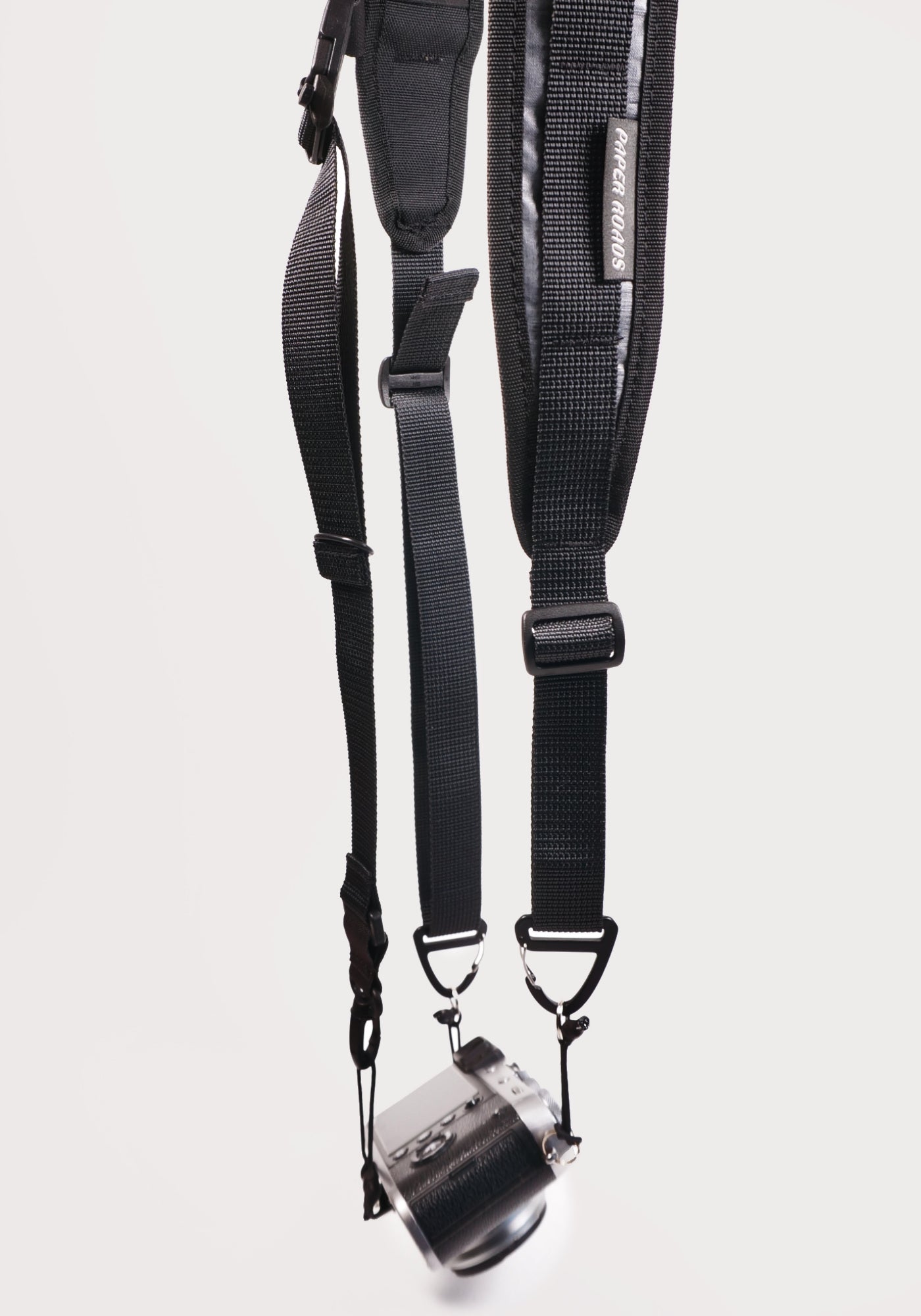 cycling 3 point camera strap harness gravel bikepacking photography film shoot single handed. Paper Roads handmade new zealand colour black grey