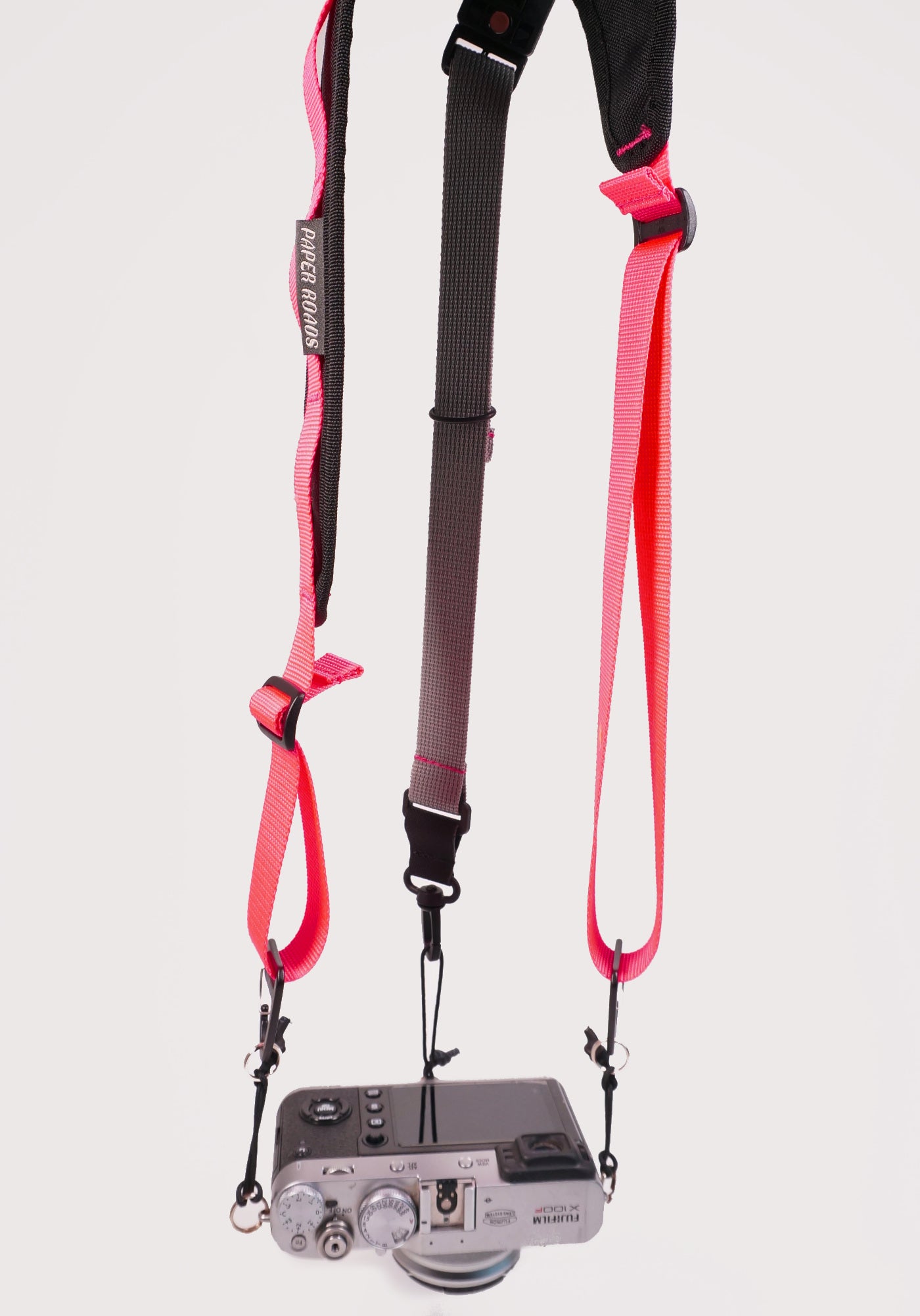cycling 3 point camera strap harness gravel bikepacking photography film shoot single handed. Paper Roads handmade new zealand colour pink grey rapha
