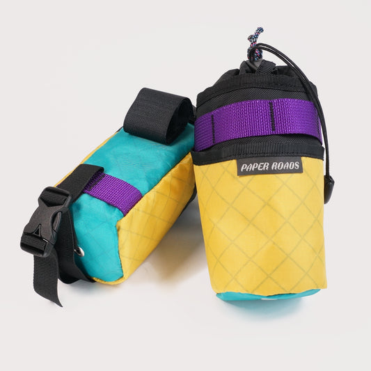 Bikepacking gravel cycling touring stem bags, treat bags, feed bags, handlebar snack bottle pouch. Paper Roads handmade in New Zealand. Colour - purple yellow teal