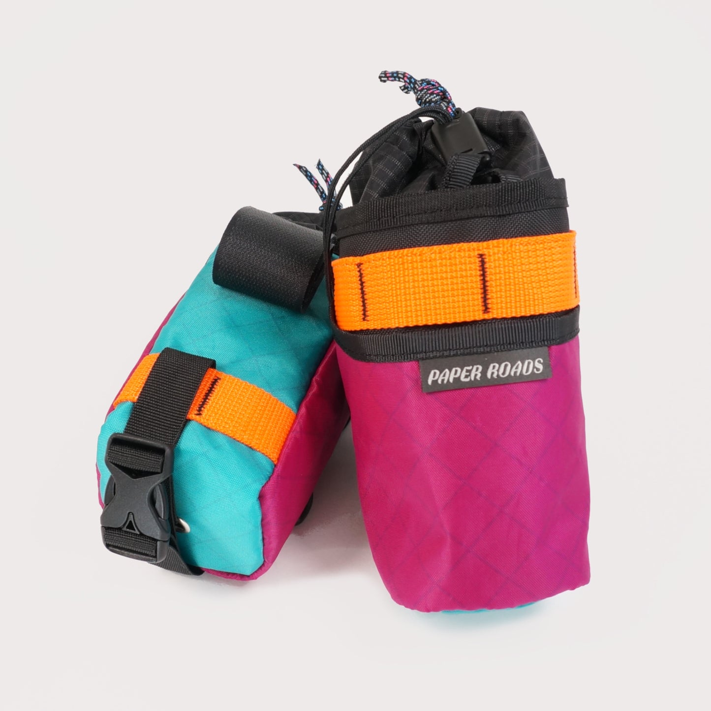 Bikepacking gravel cycling touring stem bags, treat bags, feed bags, handlebar snack bottle pouch. Paper Roads handmade in New Zealand. Colour - fuchsia orange teal