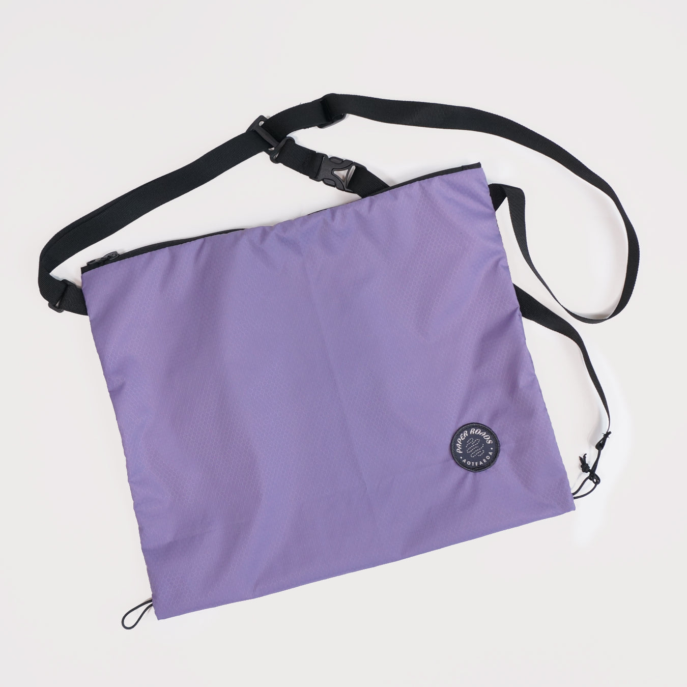 Cycling biking bikepacking touring musette. Small packable shoulder bag for shopping or commuting. Made in New Zealand by Paper Roads Aotearoa. Colourful, souvenir, gift. Lavender colour.