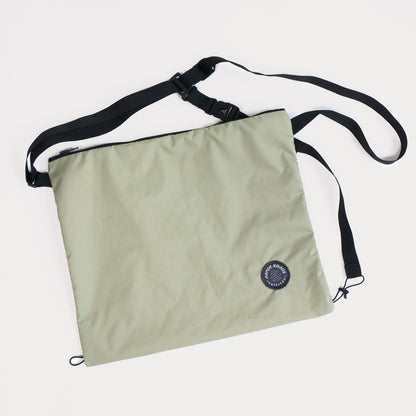 Cycling biking bikepacking touring musette. Small packable shoulder bag for shopping or commuting. Made in New Zealand by Paper Roads Aotearoa. Colourful, souvenir, gift. Moss colour.