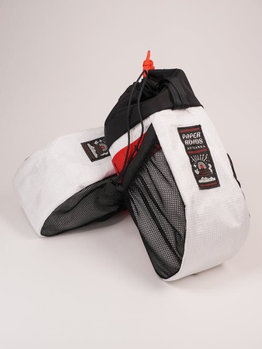 Large handlebar stem bag treat bag for cycling, commuting or bikepacking. Easy access to snacks or bottle, one handed opening. Brown with white top. Ultra tech fabric in white with red and mesh pockets.